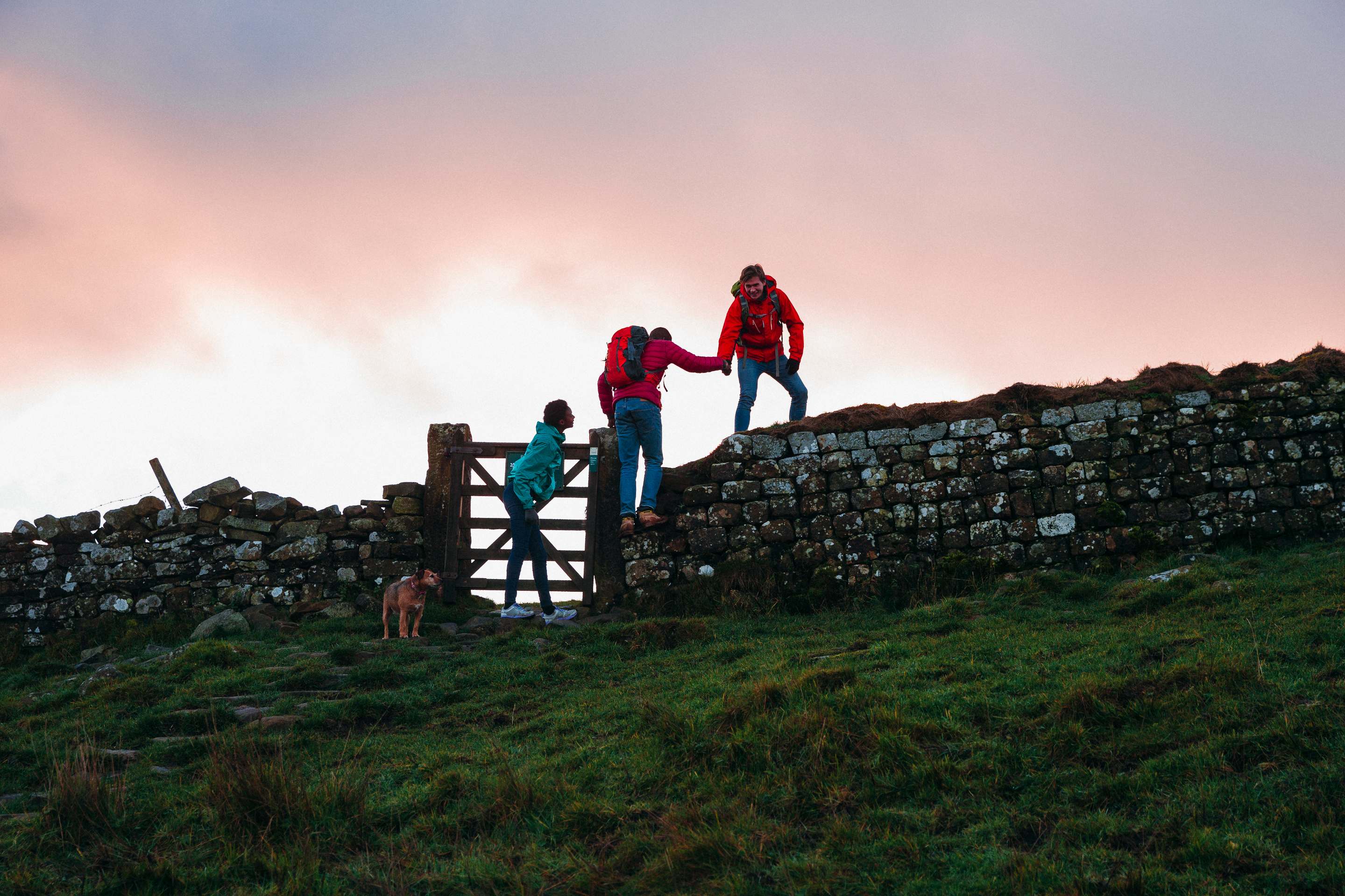 people walking on stone ledge