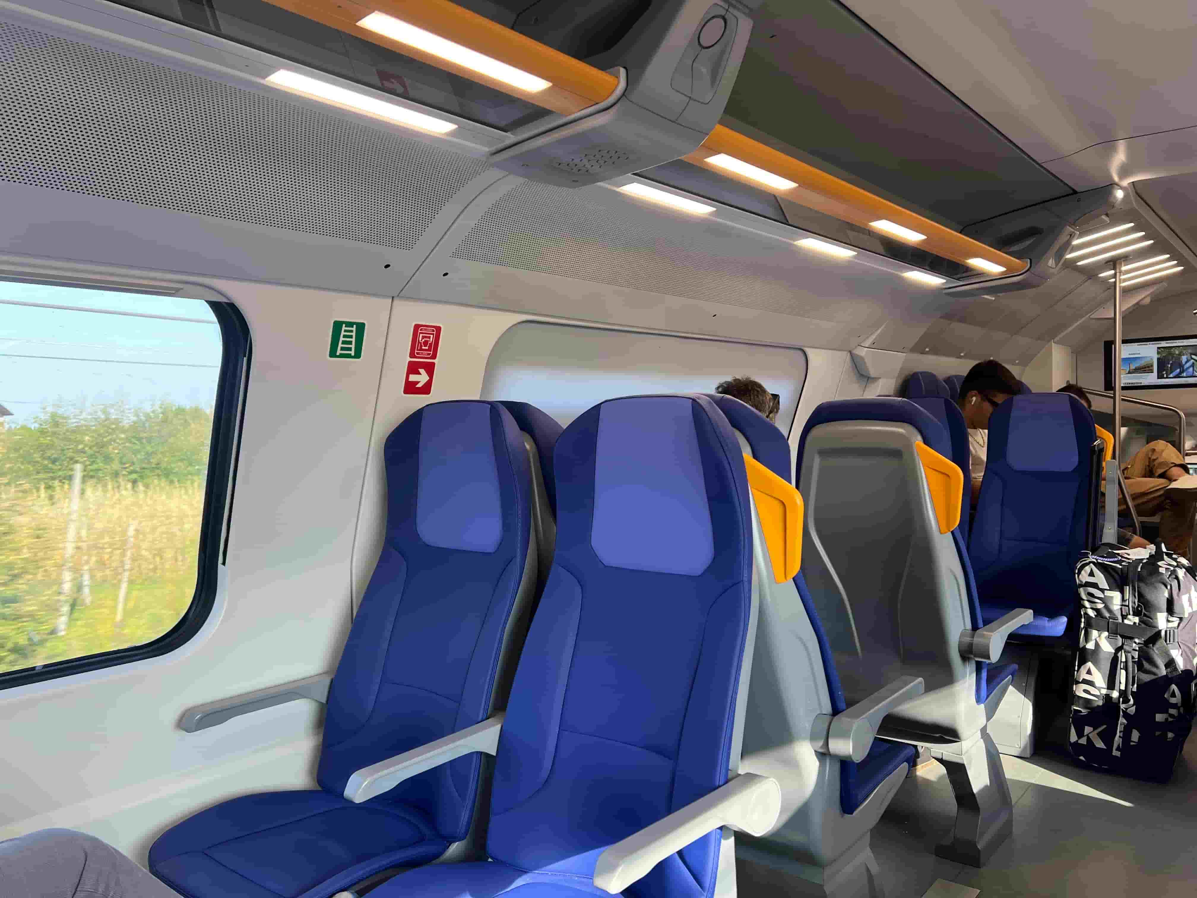 Blue and yellow seats on a train traveling from Venice, Italy to Vicenza, Italy