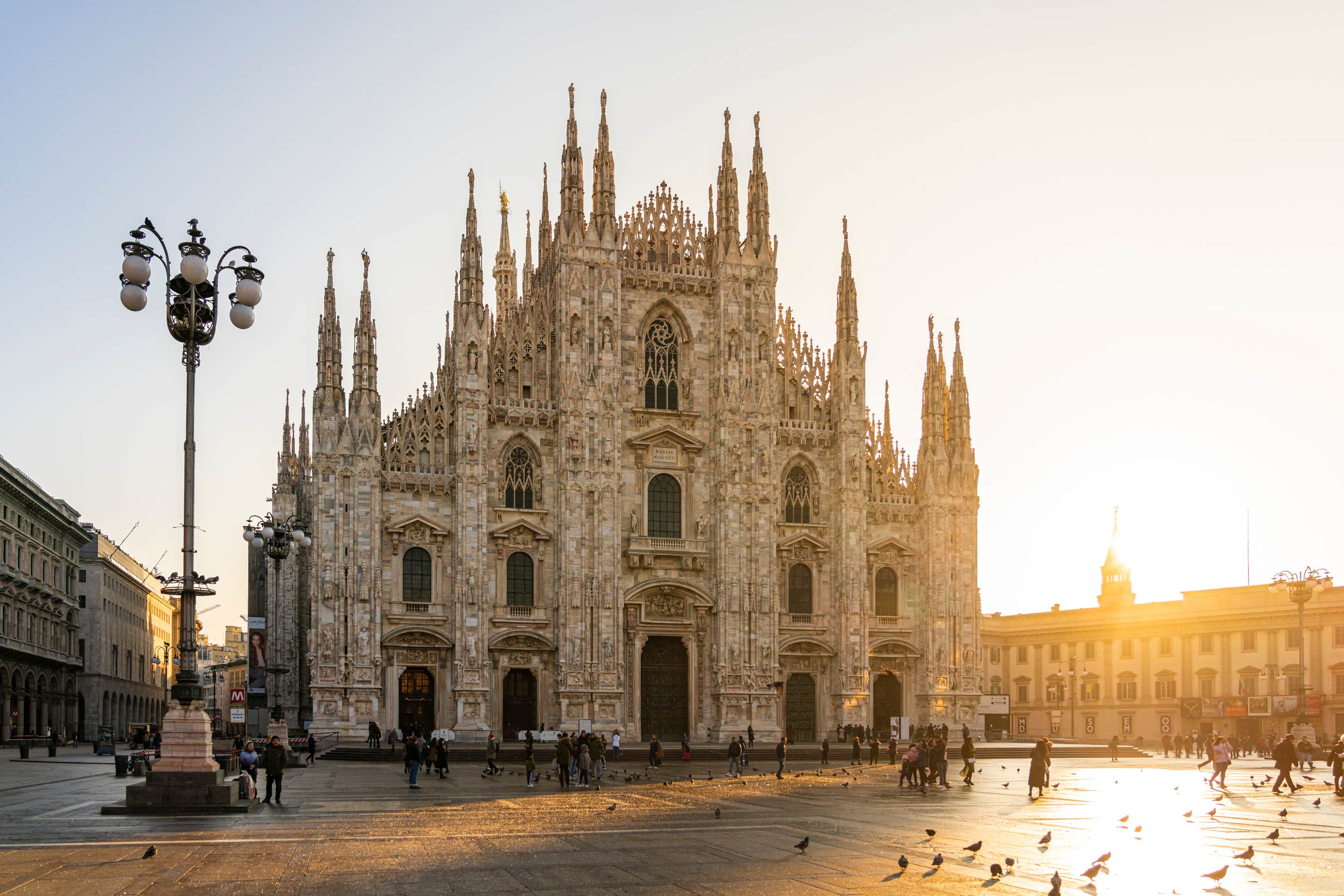 A photo showing the Milan Duomo as the sun sets