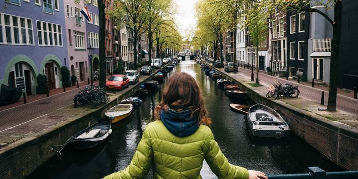 A woman looking down a canal in Amsterdam