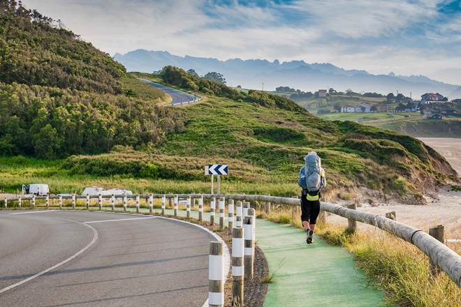 Lonely Pilgrim with backpack walking the Camino de Santiago in Spain, Way of St James