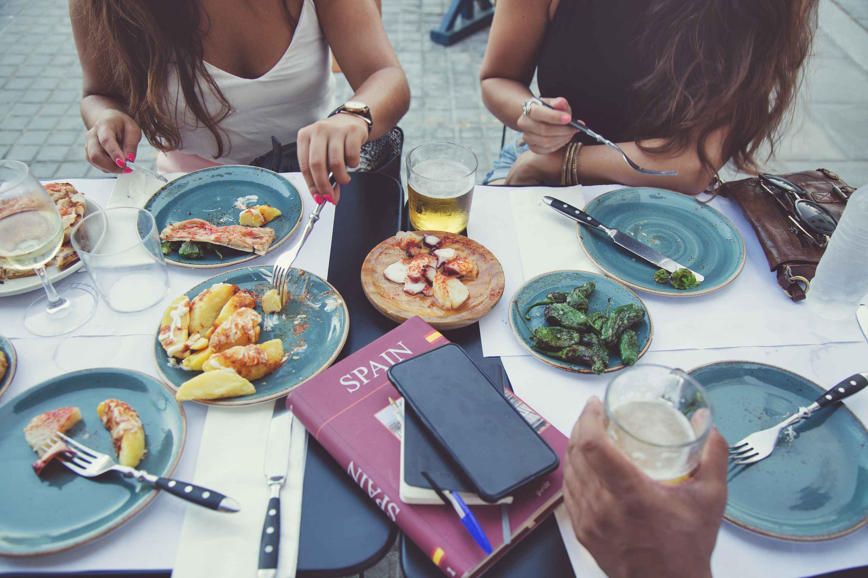 two people eating tapas