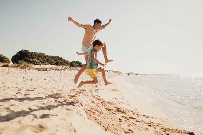 Father and son enjoying a summer day on the beach