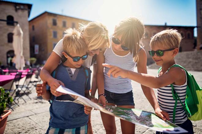 Family checking map in italian town of Massa Marittima in Tuscany
