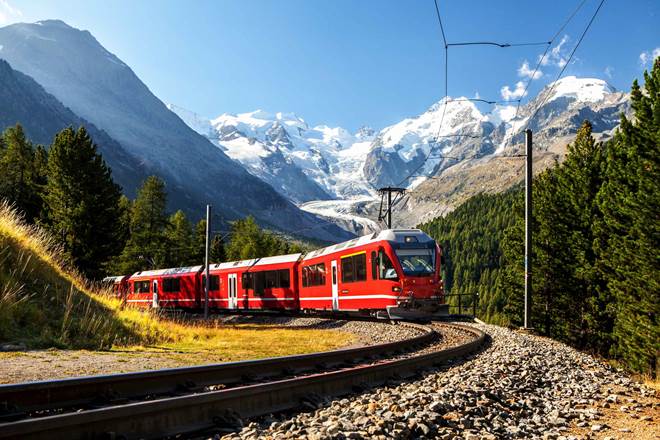 Swiss train with the Alps mountains in the background near Ospizio Bernina