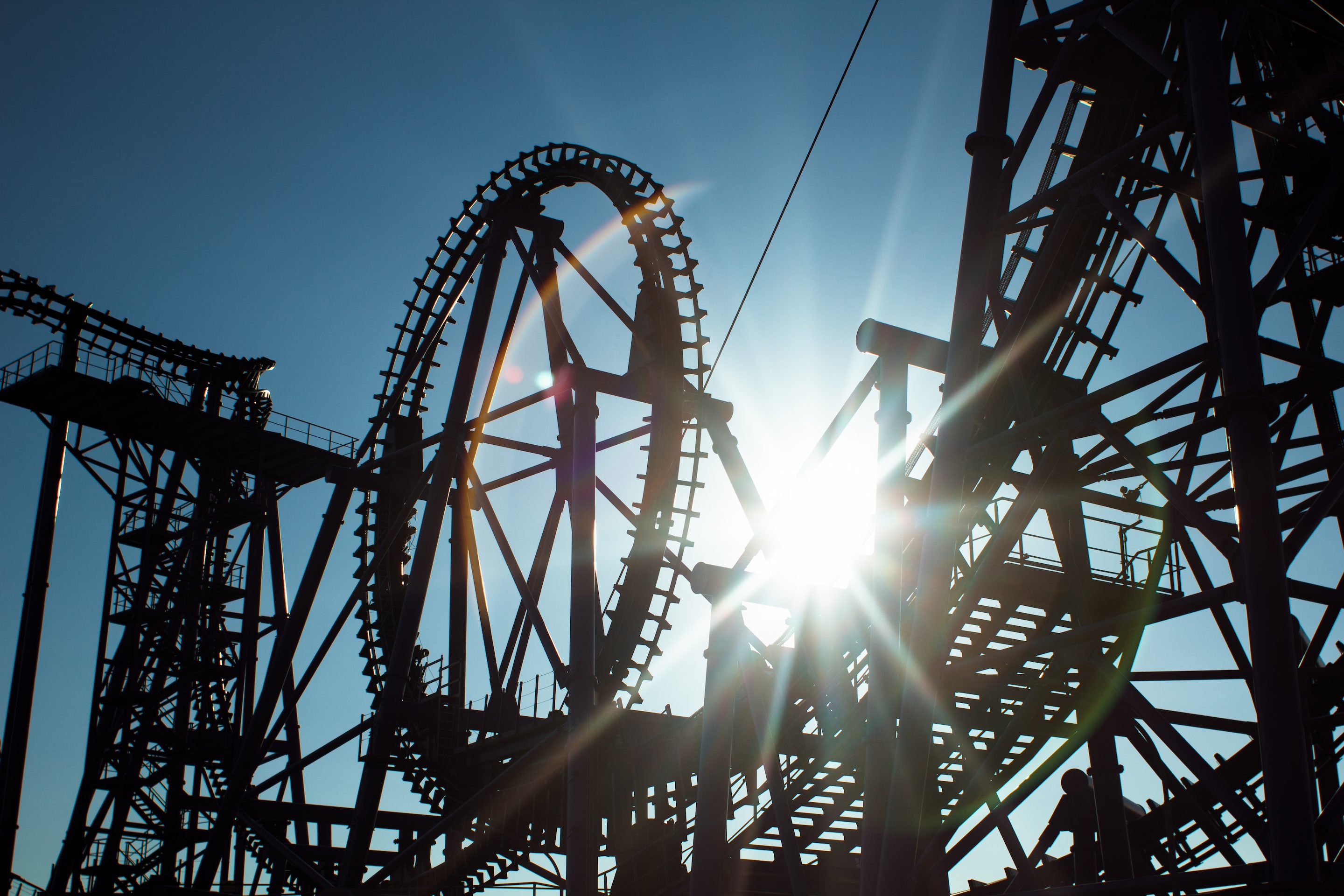 Sun shining through rollercoaster tracks at Thorpe Park