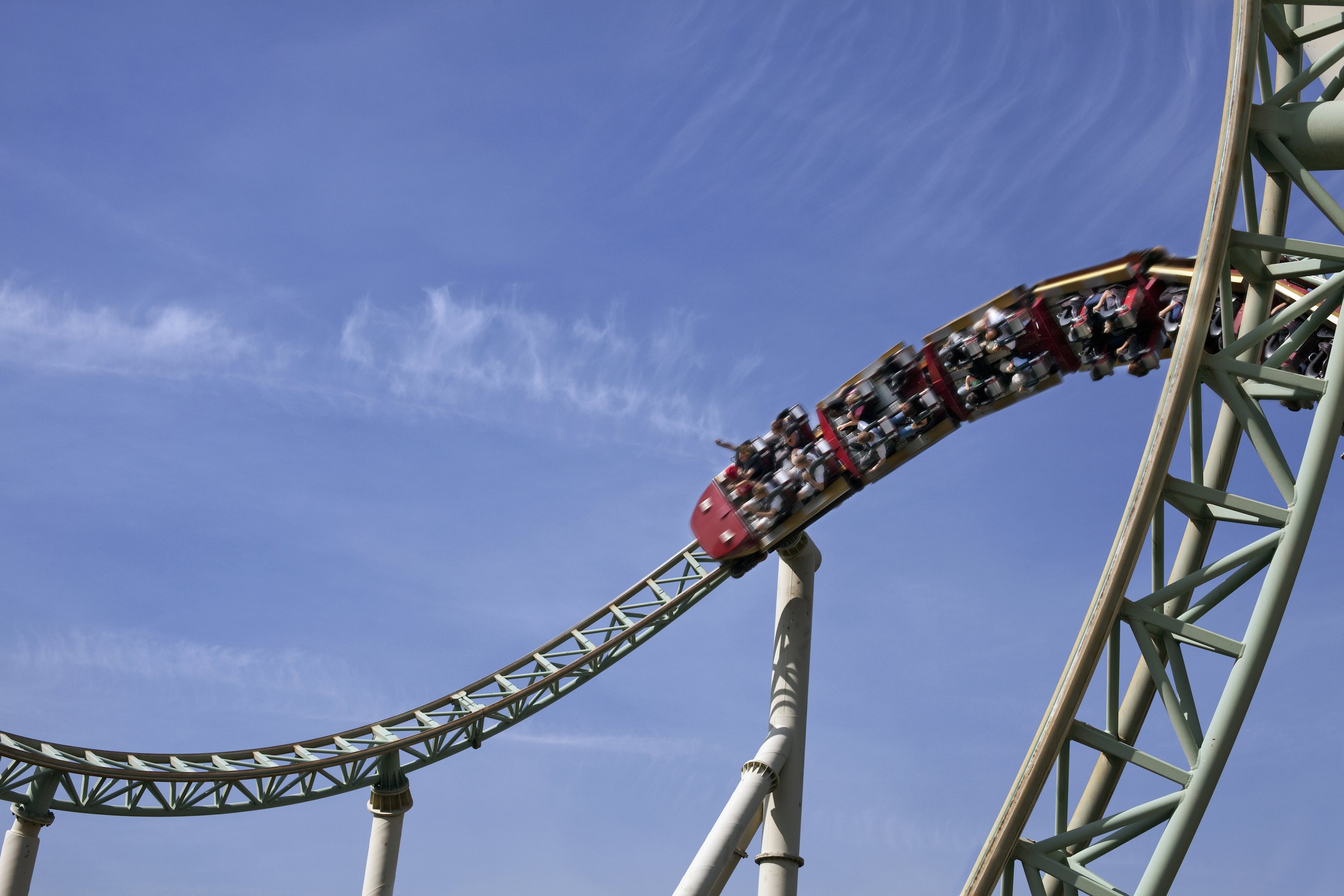 People riding rollercoaster during corkscrew