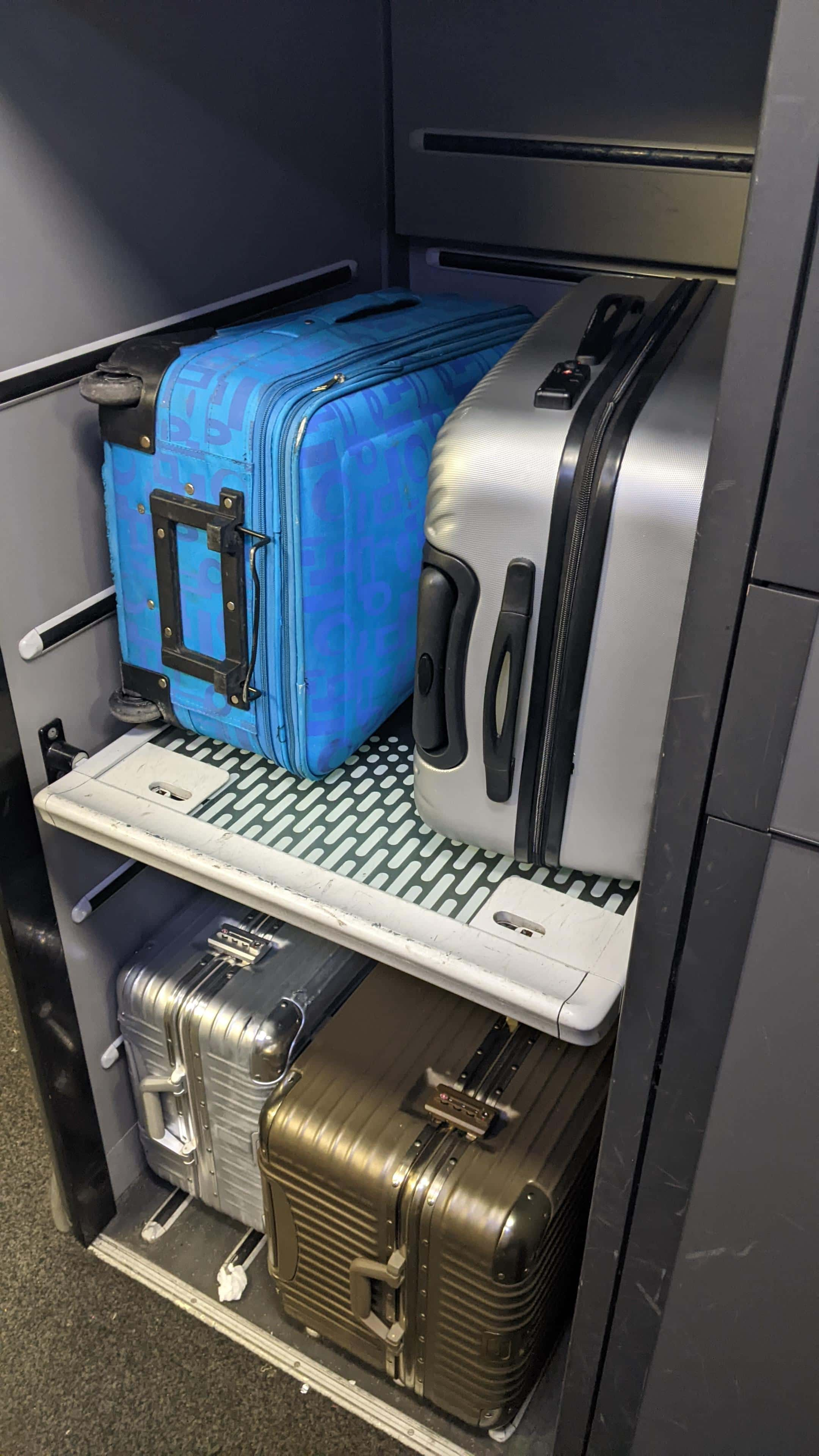 Luggage storage racks on a Eurostar train; four large suitcases, two on each rack