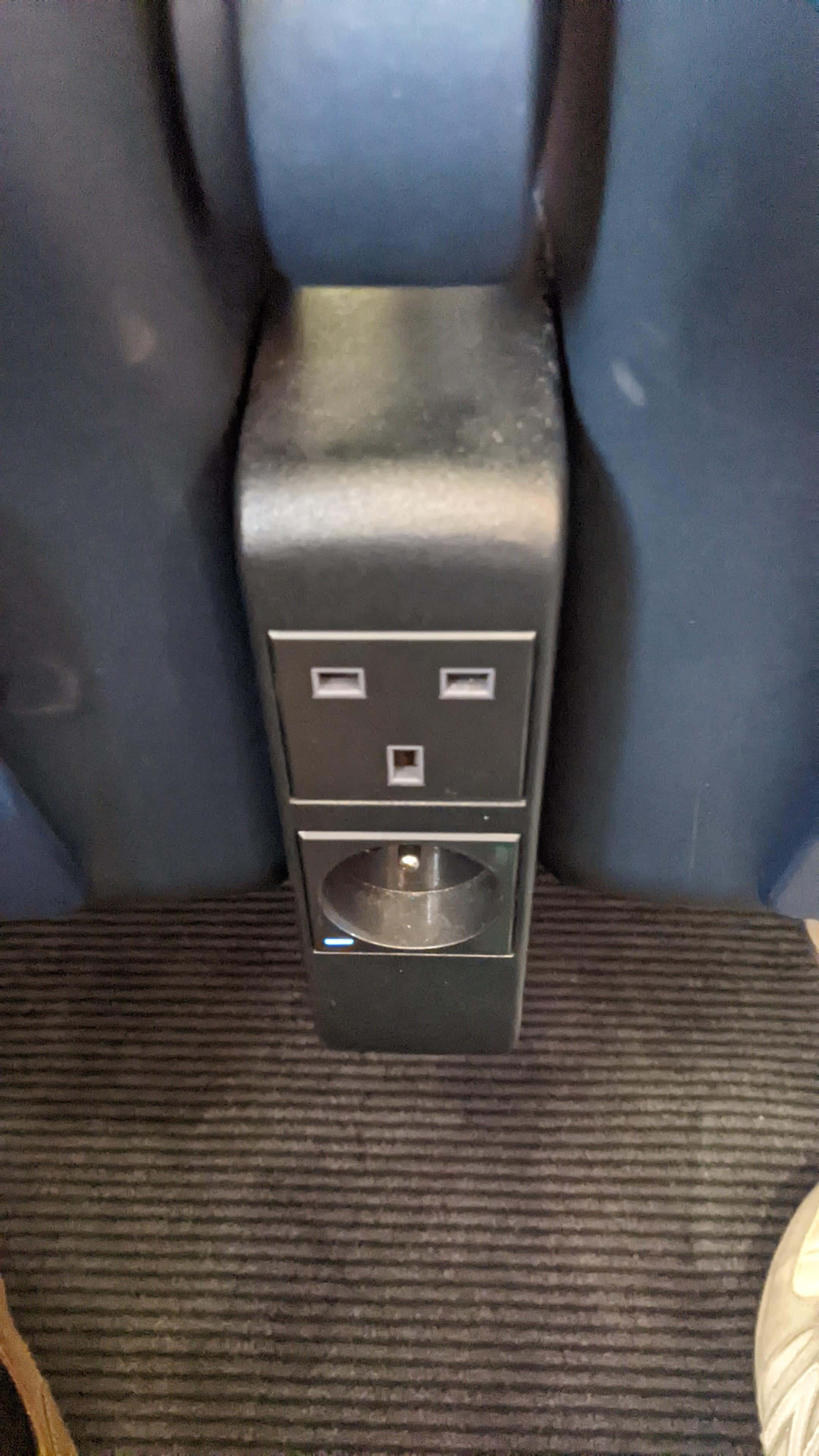 Plug sockets (one UK three pin and one European two pin) on a Eurostar train